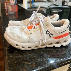 On Running White and Orange Sneakers with Cloud Cushioning